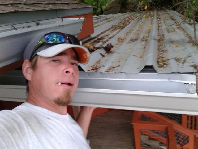 Technician working on metal roof gutter